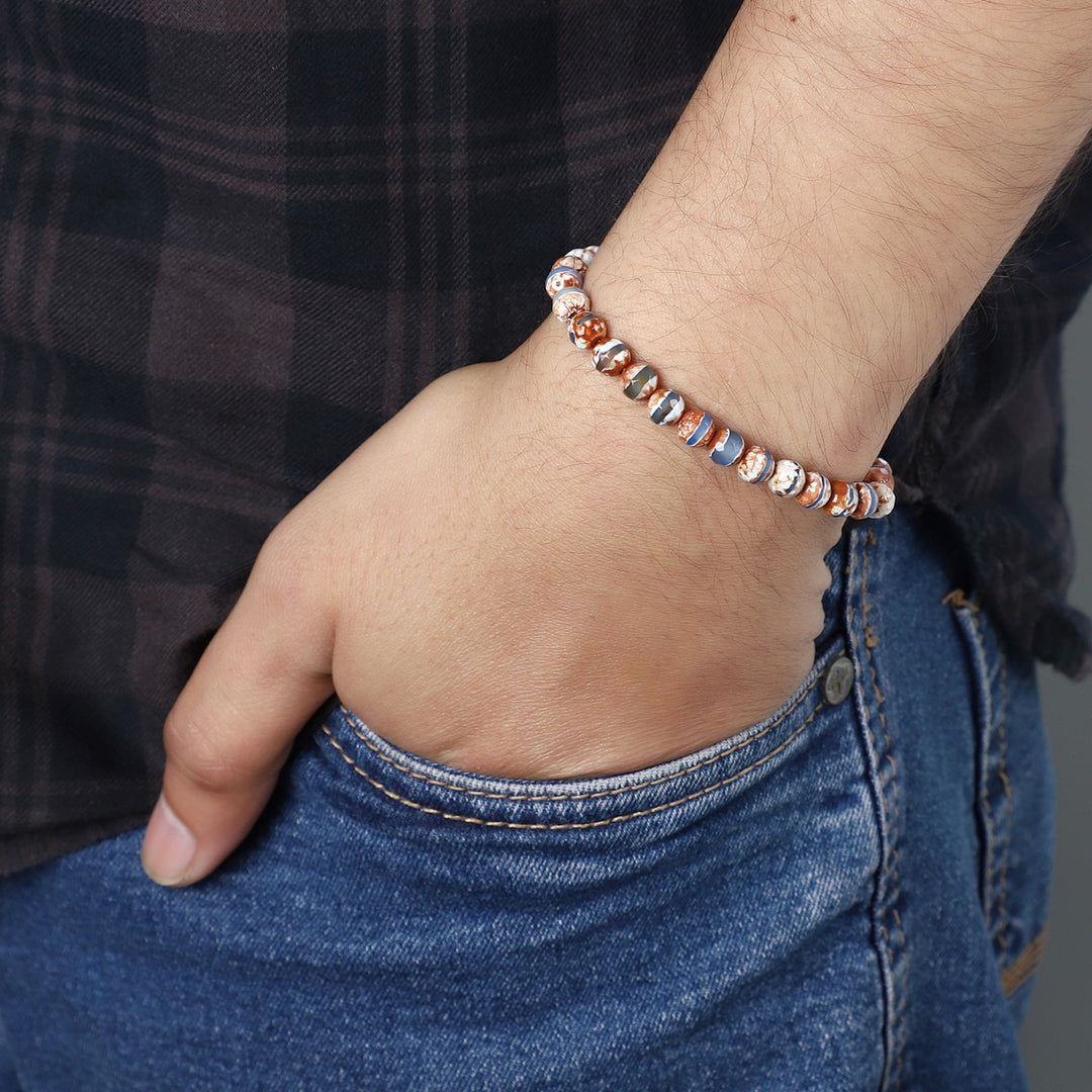 Stylish view of the Tibetan Agate Stretch Bracelet with 6mm faceted round beads, a fashionable accessory radiating spiritual insight and harmony