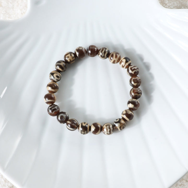 Various styling ideas for the Brown Tibetan Agate Bracelet, showcasing its versatile and fashionable appeal for everyday wear.