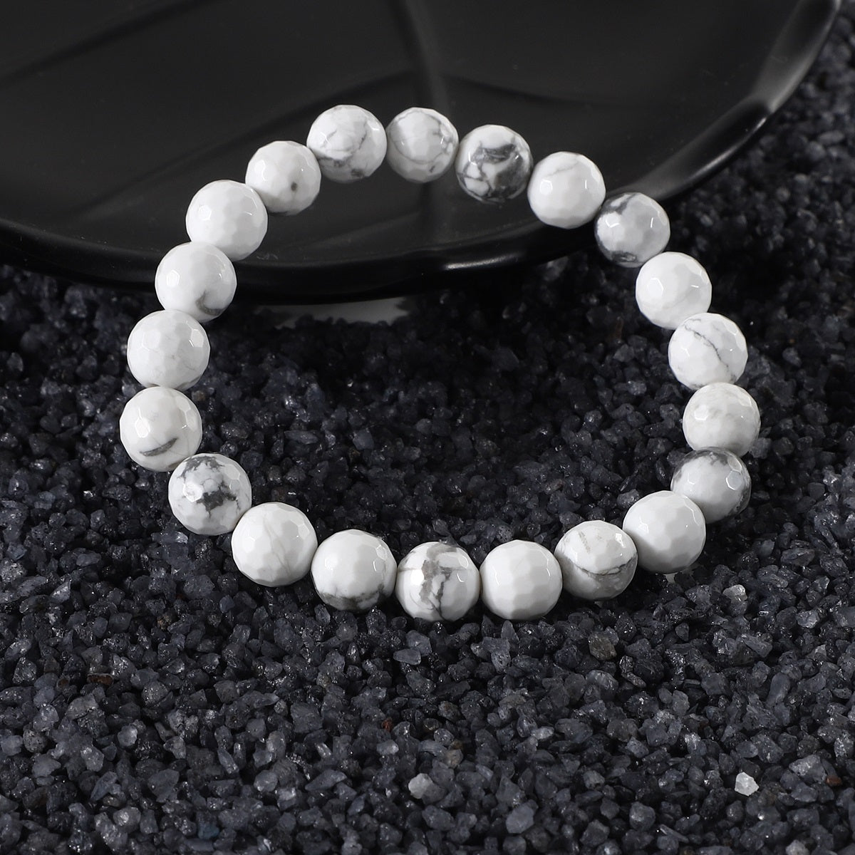 Side view of the Howlite Stretch Bracelet, showcasing its comfortable fit and the craftsmanship of the 8mm faceted beads for a sophisticated look