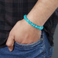 Adorned wrist showcasing the Sky Blue Quartz Bracelet, a stylish accessory promoting enhanced communication and emotional healing