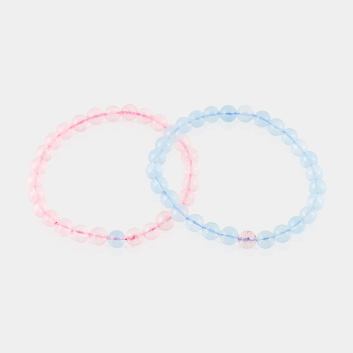 Symbolic representation of love and harmony through a couple's bracelet adorned with Aquamarine and Rose Quartz gemstones