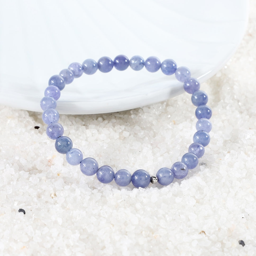 "A collection of Tanzanite Stretch Bracelets, each unique in size and showcasing the Stone of Enlightenment for versatile elegance.