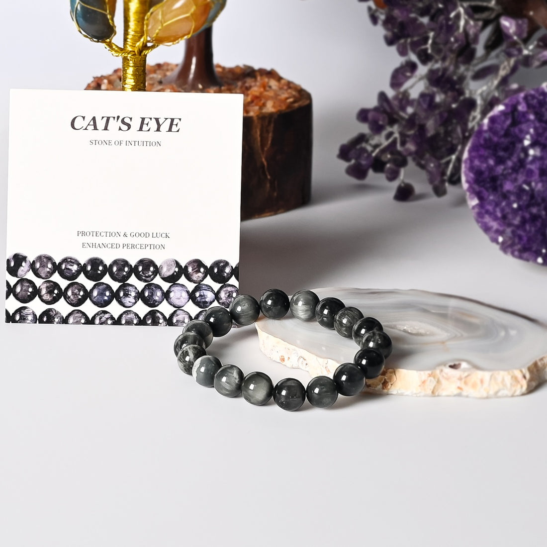 Chic Cat's Eye Stretch Bracelet showcasing 10mm gray and black smooth round beads, a stylish accessory for enhanced intuition.