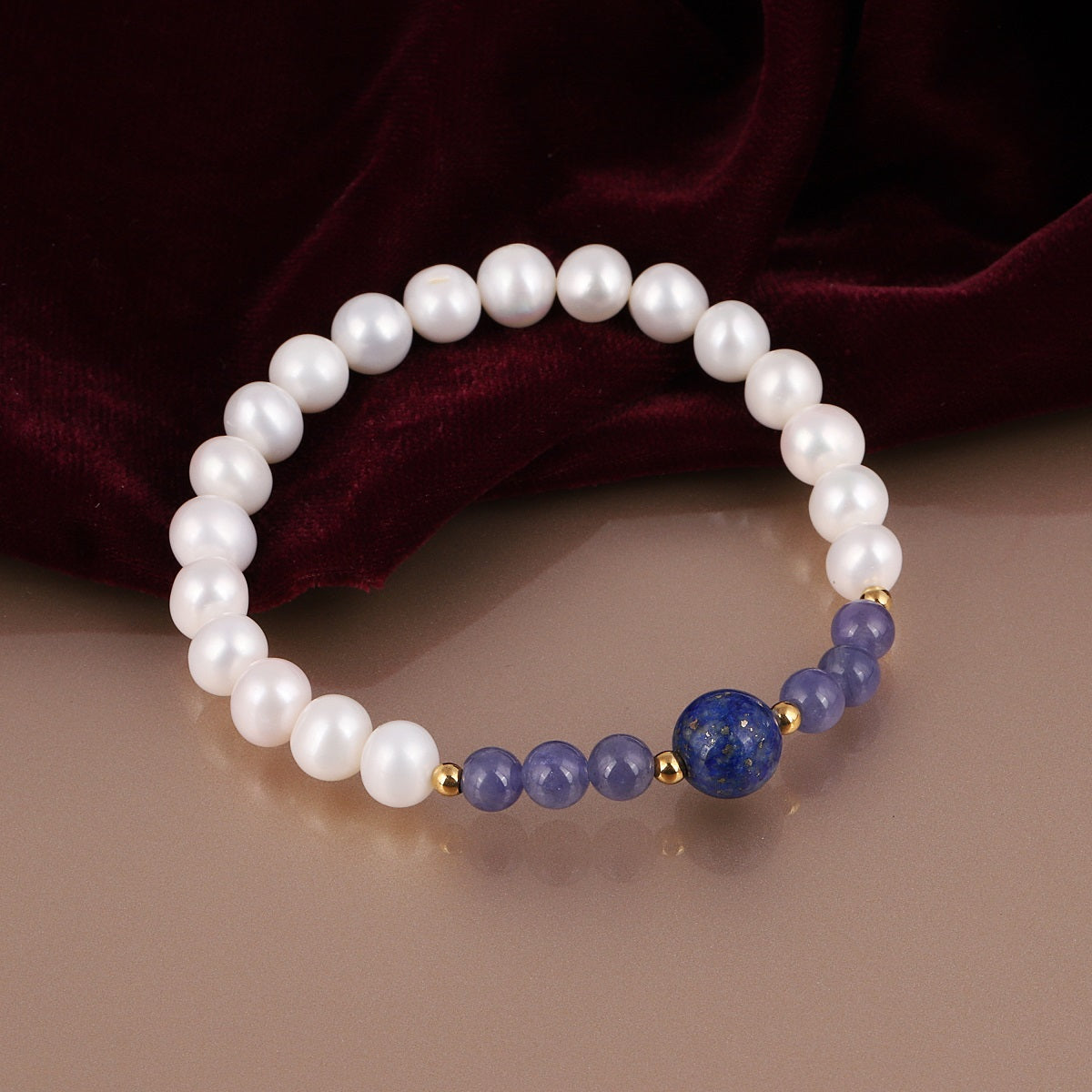 Handcrafted stretch bracelet featuring smooth round tanzanite and Lapis Lazuli gemstones in captivating blue