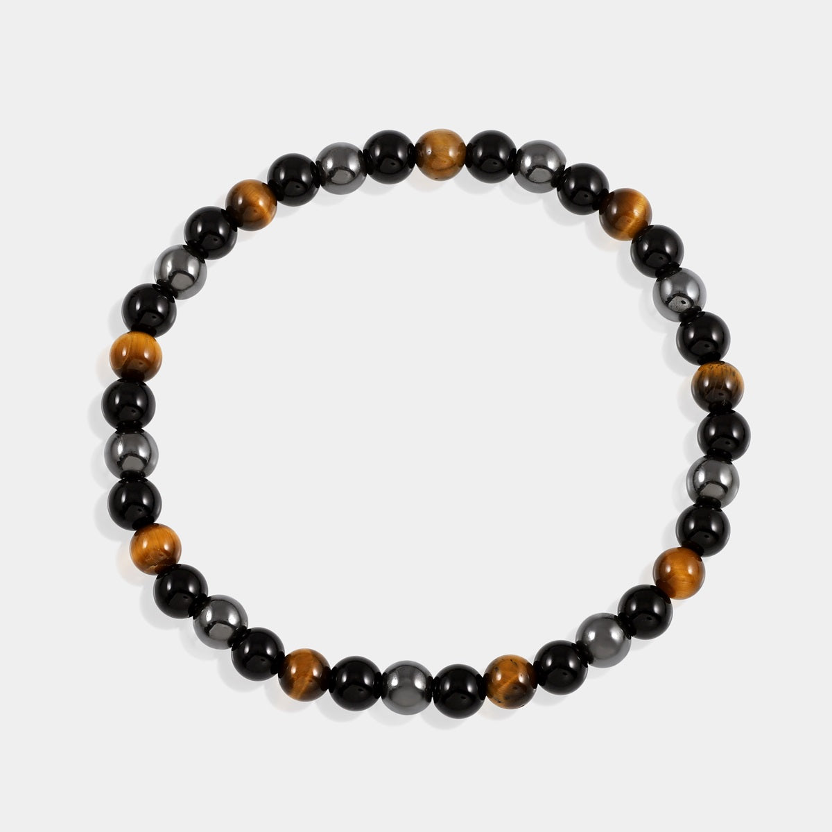Detailed view of a 6mm and 8mm smooth round Black Onyx bead, representing grounding and protective energies in the Triple Protection Bracelet