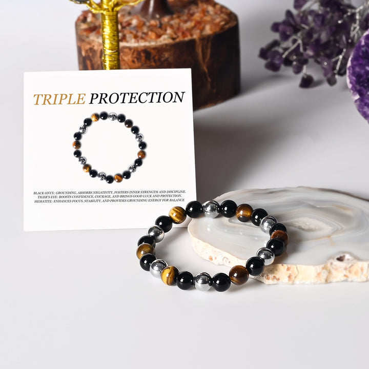 Stylish Triple Protection Stretch Bracelet featuring 6mm and 8mm smooth round beads of Golden Tiger's Eye, Black Onyx, and Hematite.