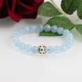 Friendship bracelet showcasing the beauty of Aquamarine beads and the Evil Eye charm on a stretchable cord.