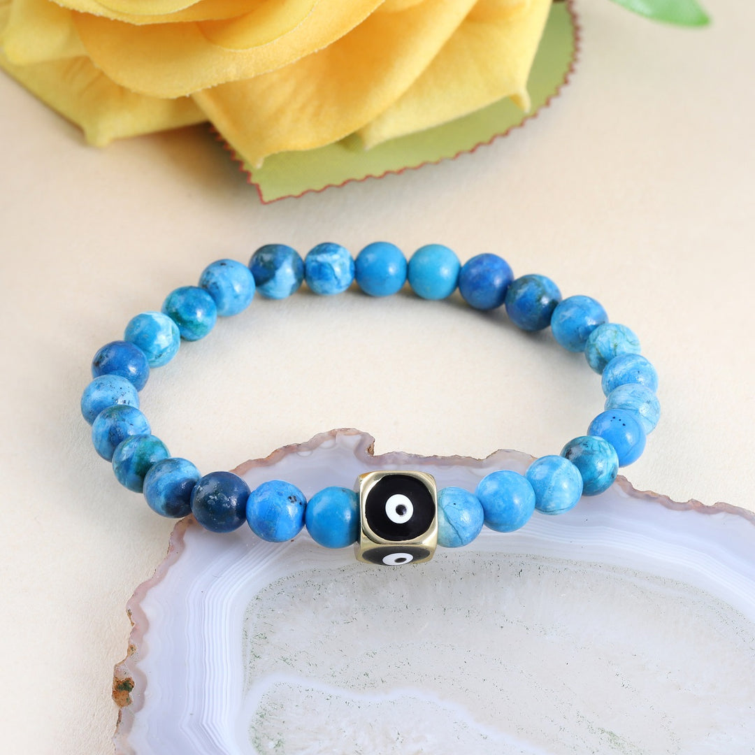 A handcrafted bracelet with Turquoise gemstone beads and an Evil Eye charm, offering a harmonious blend of style and well-being.