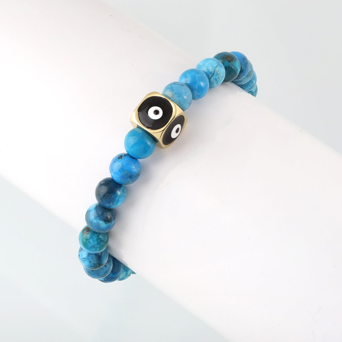  An intricate bead with the Evil Eye symbol, believed to ward off negativity and provide a shield of protection, on a gemstone bracelet.