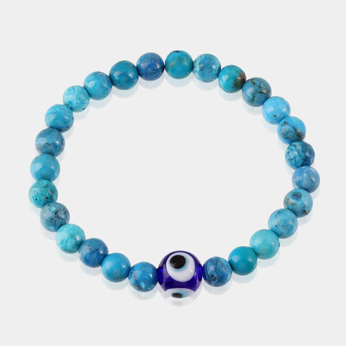 An intricate bead with the Evil Eye symbol, believed to ward off negativity and provide a shield of protection, on a gemstone bracelet.