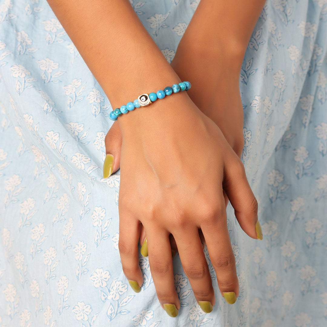 A bracelet adorned with smooth round Turquoise gemstone beads, showcasing a calming blue hue reminiscent of the sky and sea.