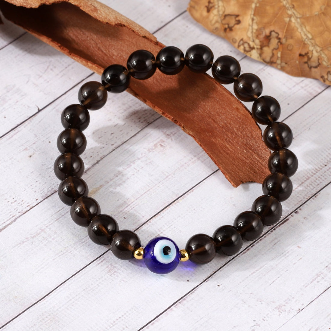 Close-up of smooth round Smoky Quartz gemstone beads in a captivating smoky hue.