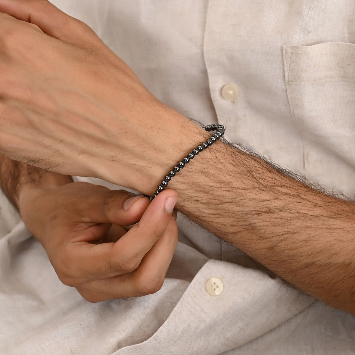 Black Hematite Stretch Bracelet: Smooth round 4mm beads in captivating black hue.