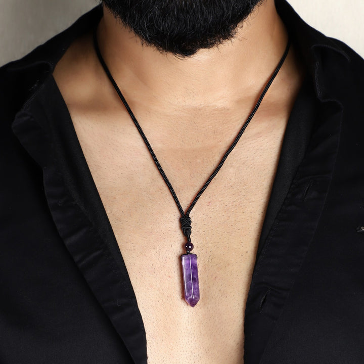  A stunning pendant necklace featuring a natural Amethyst gemstone wrapped in an intricate design.