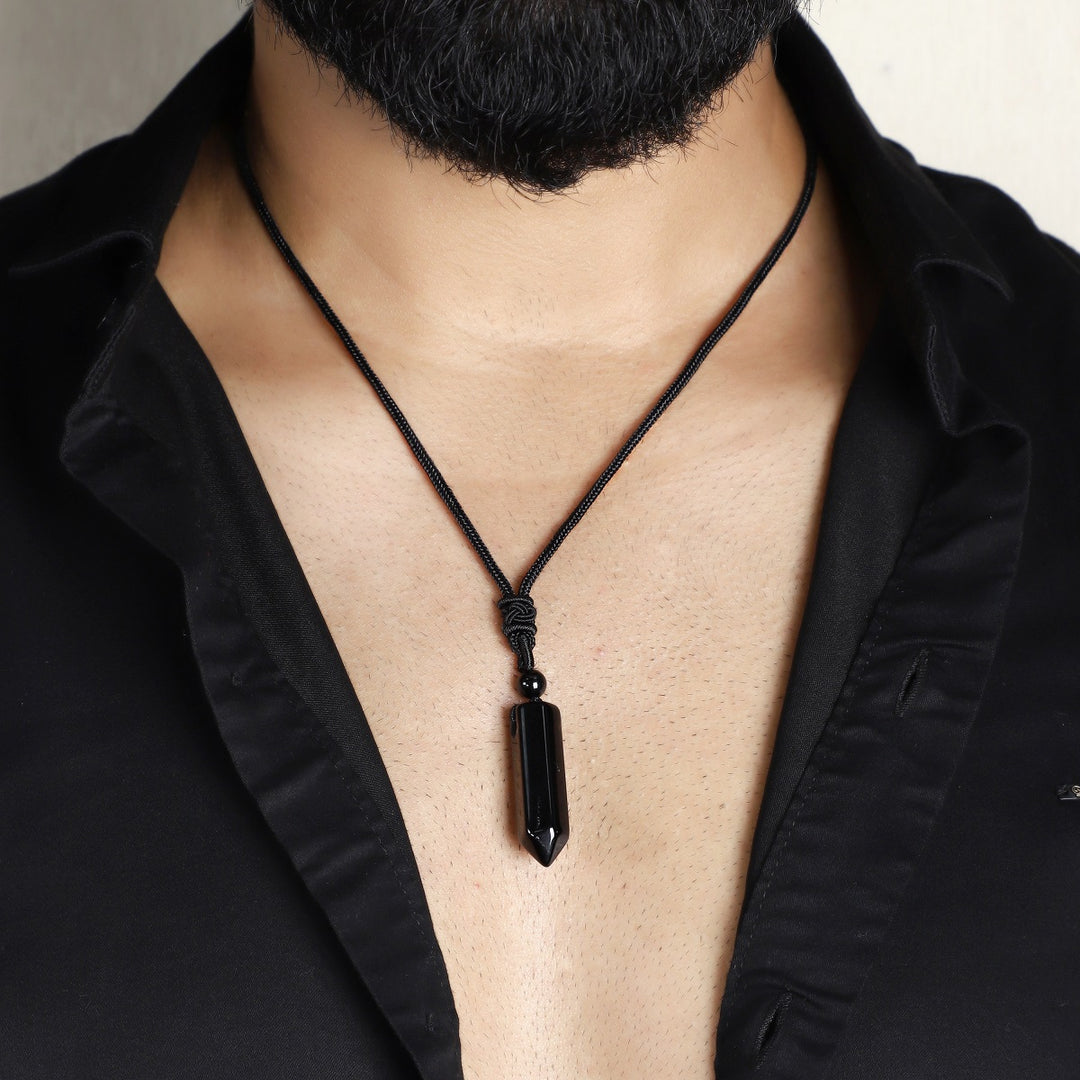 A stunning pendant necklace featuring a natural Black Onyx gemstone wrapped in an intricate design.