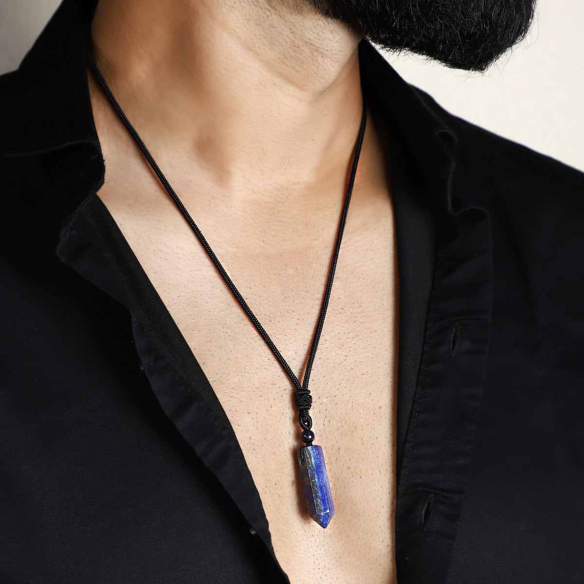 A stunning pendant necklace featuring a natural Lapis Lazuli gemstone wrapped in an intricate design.