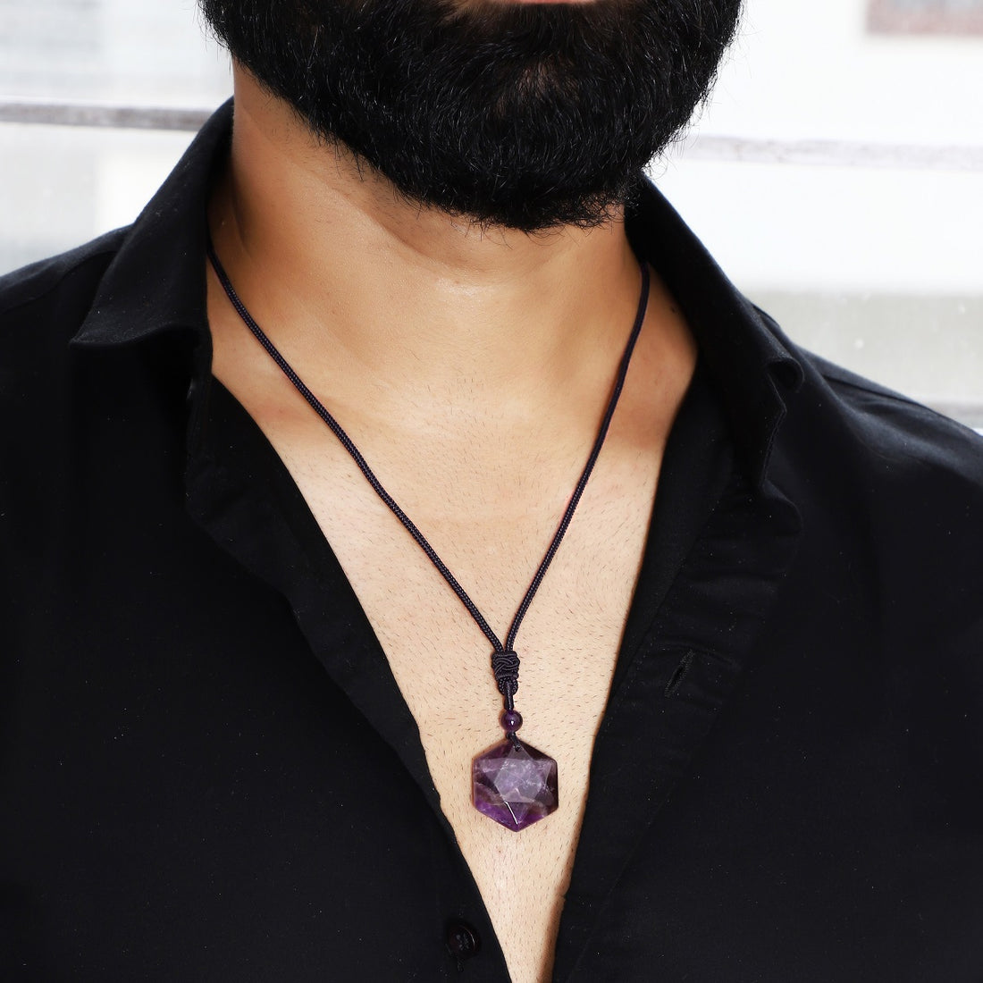  A visual representation of the weight of the pendant necklace, emphasizing its substantial yet comfortable feel on the neckline.