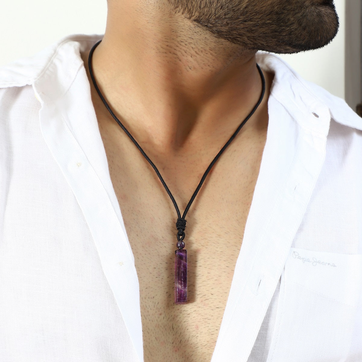 Pendant necklace featuring an Amethyst gemstone in a wrapped design.