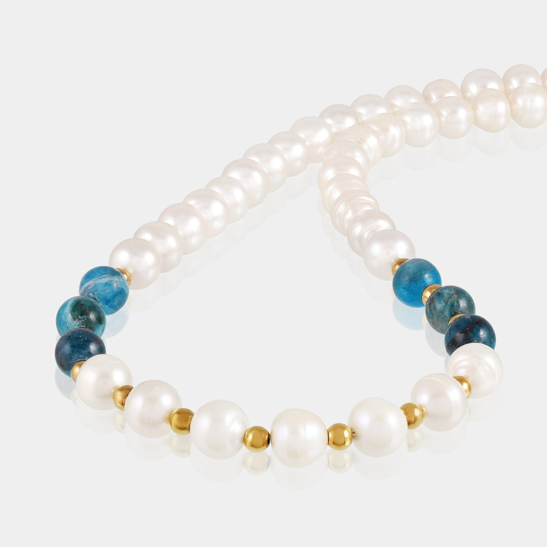 Detailed craftsmanship of the necklace's smooth potato-shaped pearls, round apatite beads, and delicate hematite accents.