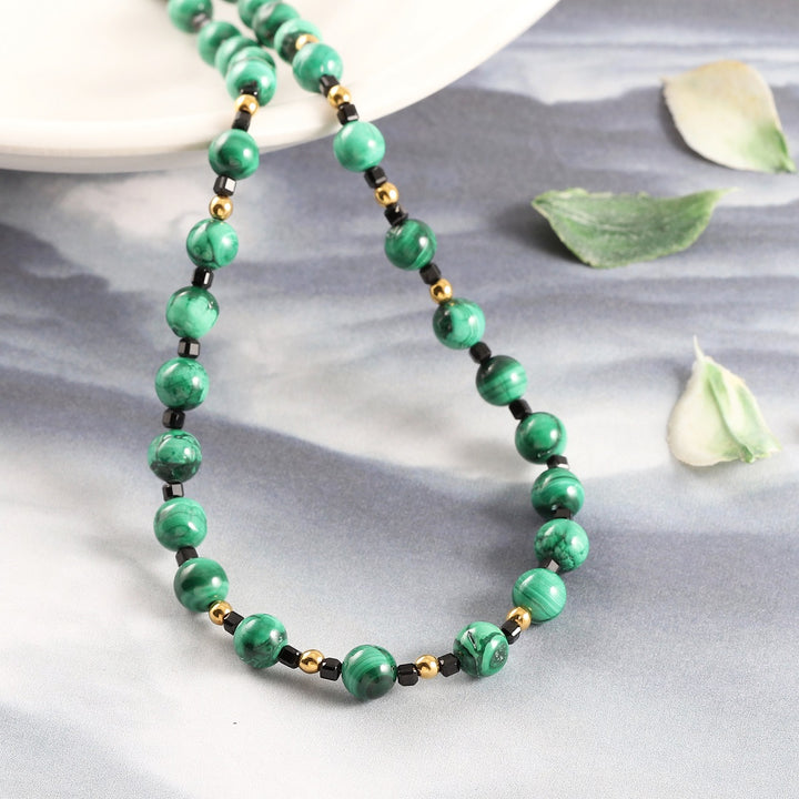 Luxurious Gemstone Jewelry with Green, Black, and Gold Beads