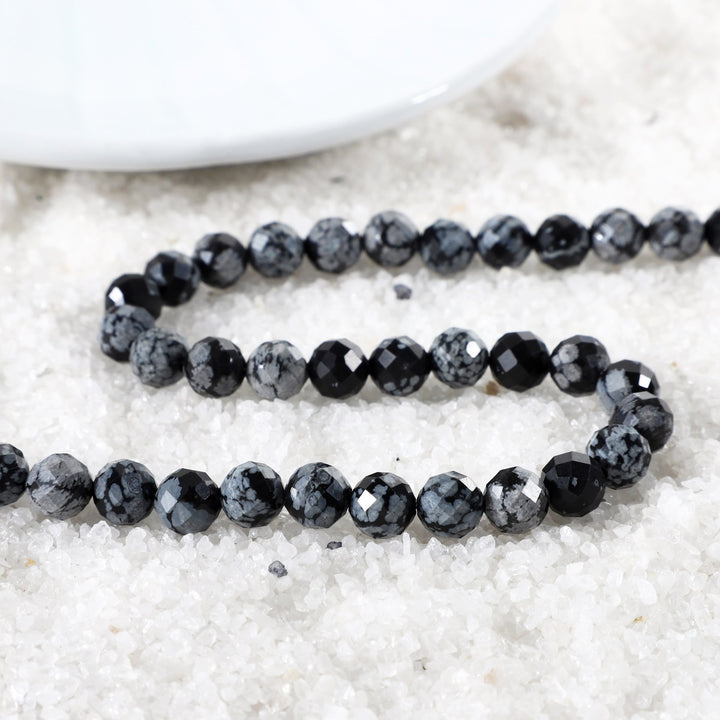 Close-up of Faceted Round Snowflake Obsidian Beads