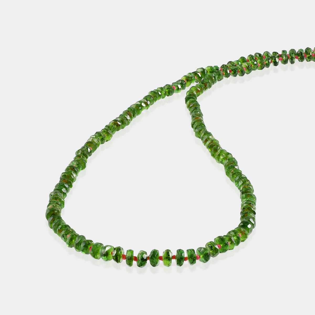 Close-up of faceted rondelle Chrome Diopside gemstone beads on necklace