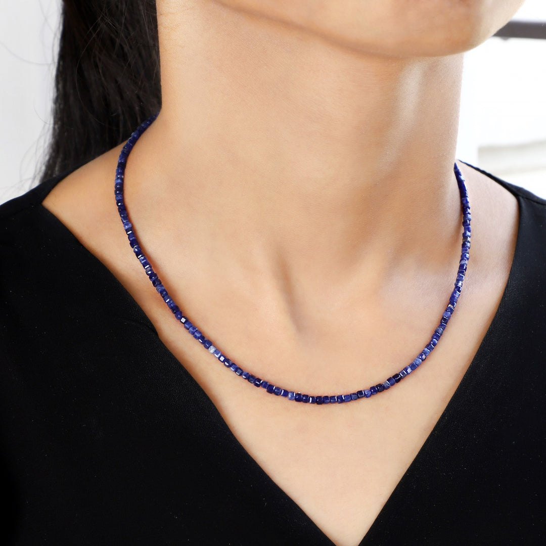 Graceful model showcasing the Sodalite Serenity Cube Necklace, radiating elegance and tranquility