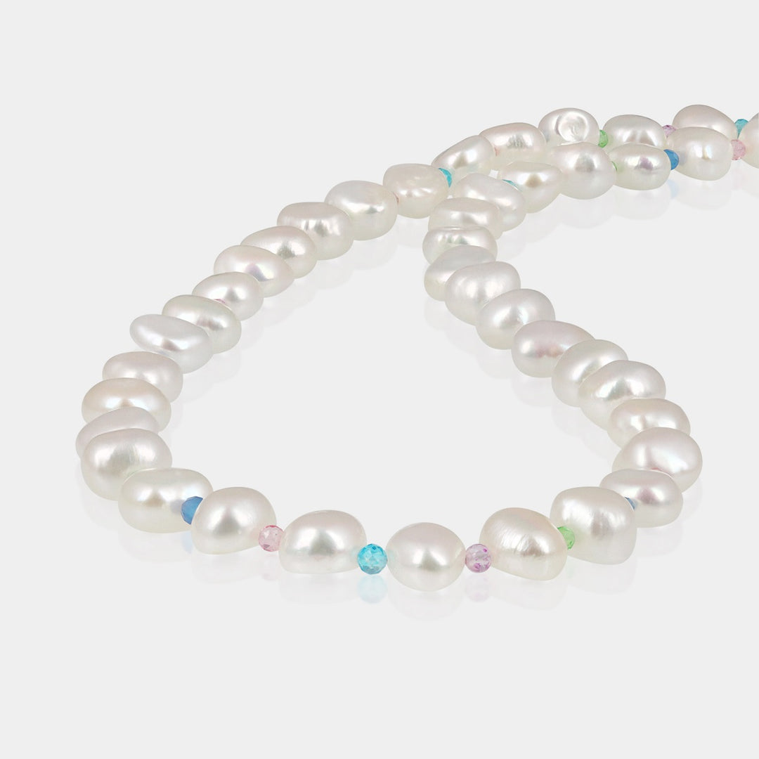 This exquisite piece features smooth nugget-shaped pearls and vibrant crystal quartz beads