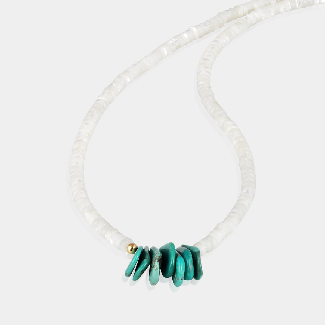 This exquisite piece features smooth heishi-shaped Mother of Pearl beads and pear-shaped Turquoise gemstones