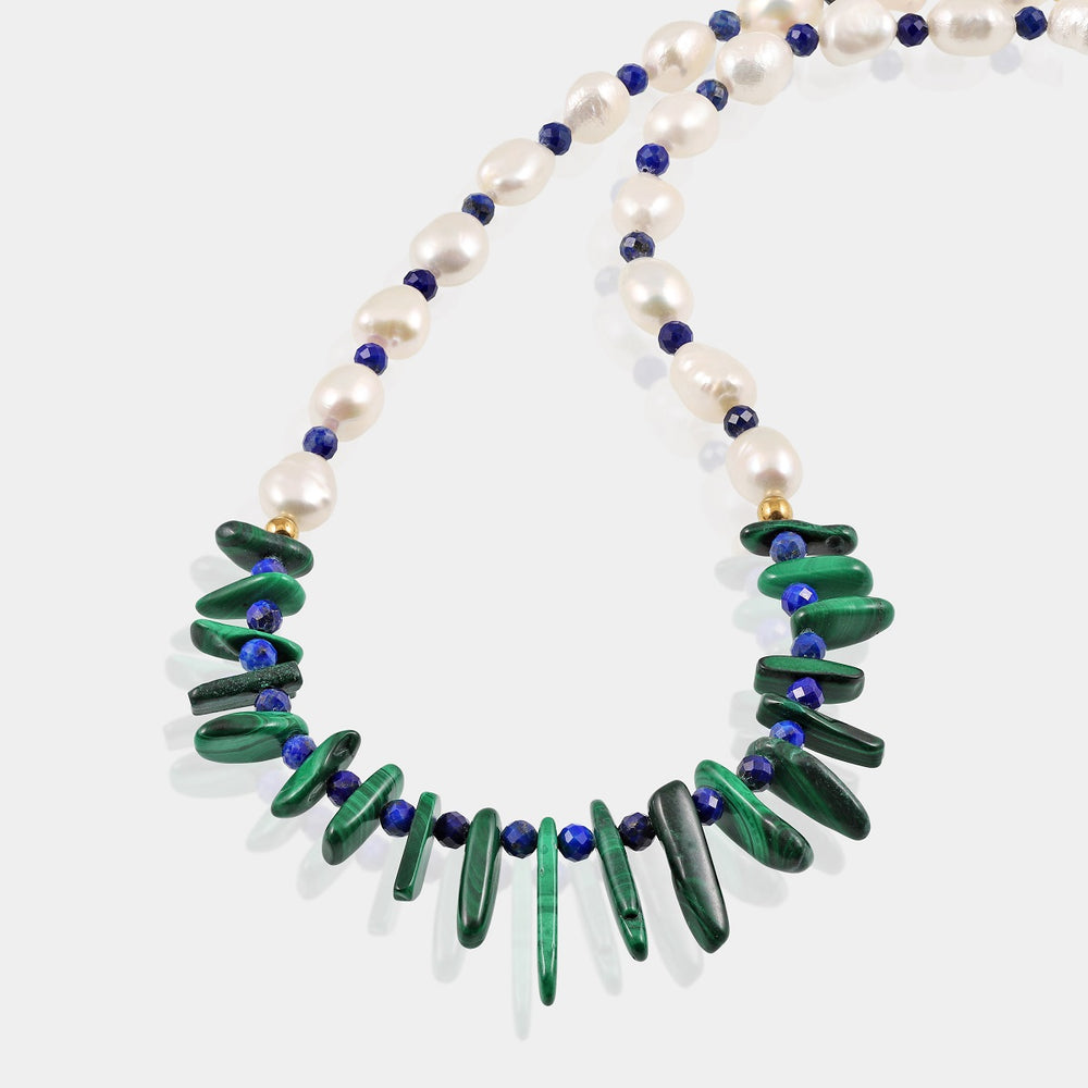 Smooth tumble-shaped Pearls in elegant white, radiating purity and sophistication and Faceted round Lapis Lazuli gemstones in deep blue, exuding regal allure