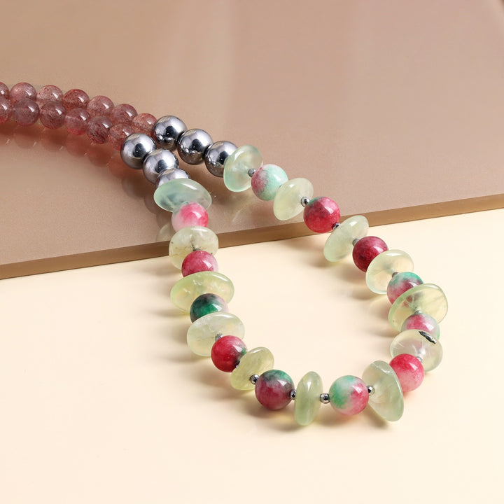 Round Strawberry Quartz gemstone beads in red and green colors, adding a pop of vibrancy