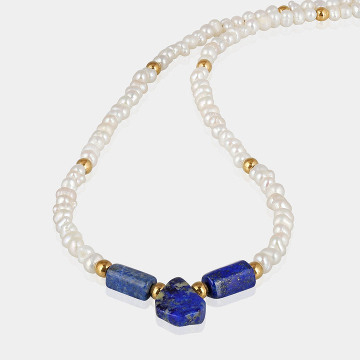 smooth pear and tube-shaped Lapis Lazuli gemstone beads in vibrant blue color. Lustrous white Pearl beads arranged in smooth rondelle shapes, adding elegance and grace.