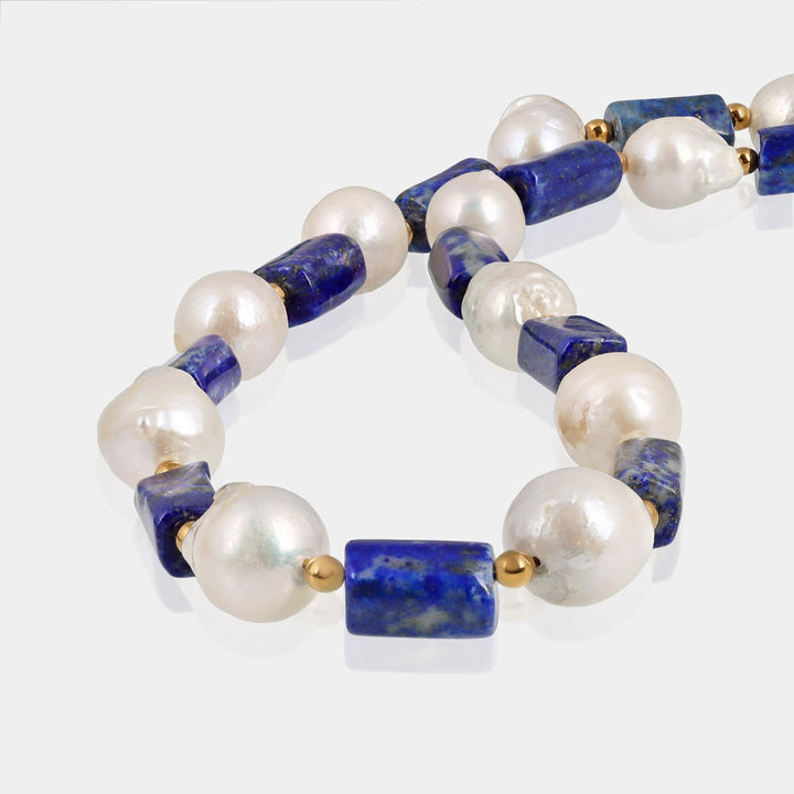 Close-up of smooth tube-shaped Lapis Lazuli gemstone beads on silver necklace