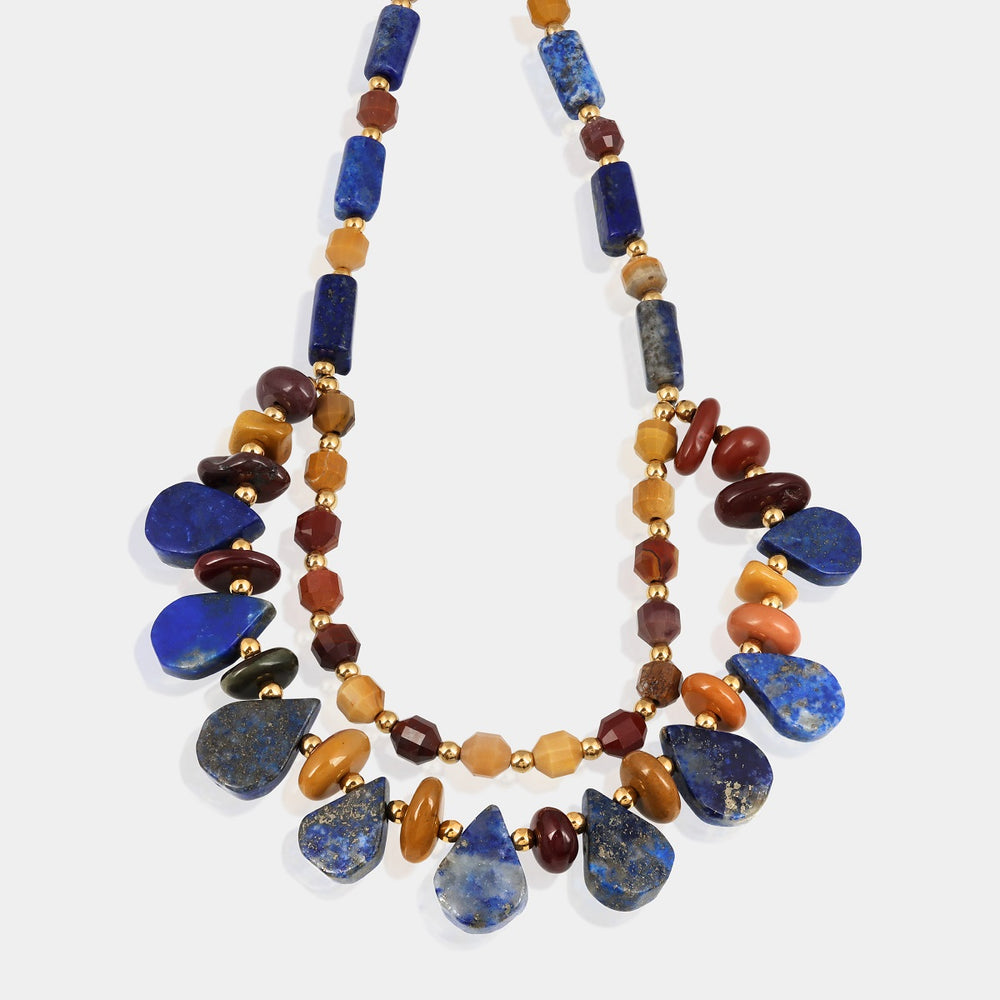 Natural Lapis Lazuli gemstone showcasing its deep blue color and smooth tube and pear shapes.