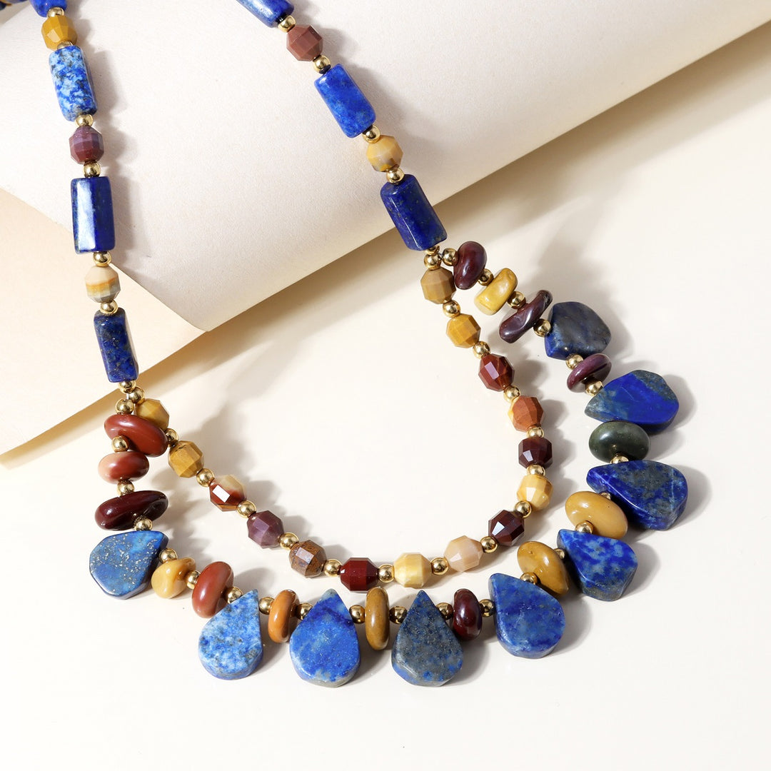 Multicolor Mookaite gemstone displaying faceted lantern and smooth nugget shapes, radiating vibrant hues