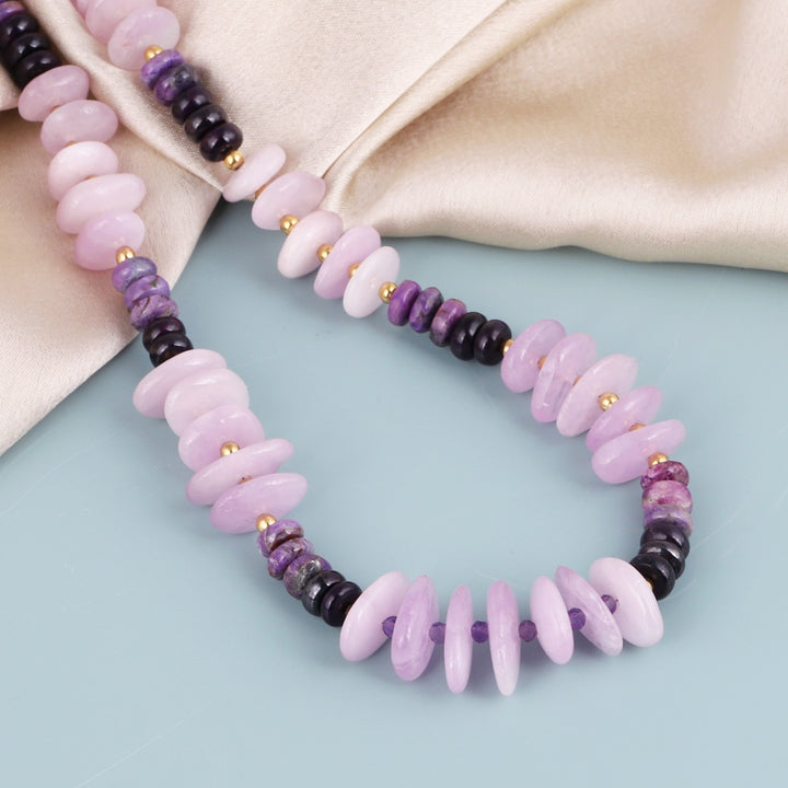 Smooth rondelle-shaped sugilite gemstone beads in purple color