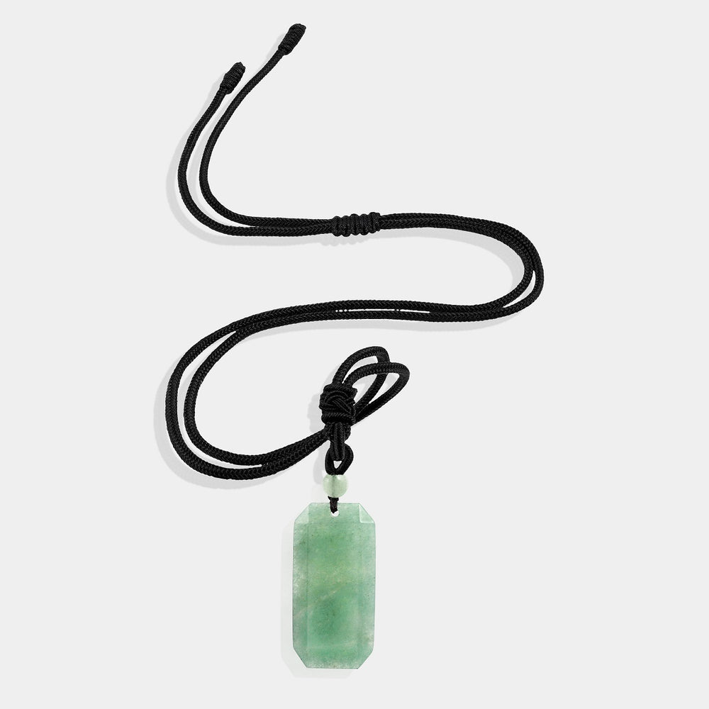 A close-up view of the pendant necklace showcasing the smooth baguette-shaped green aventurine gemstone wrapped with an adjustable rope necklace, displaying its soothing green color.