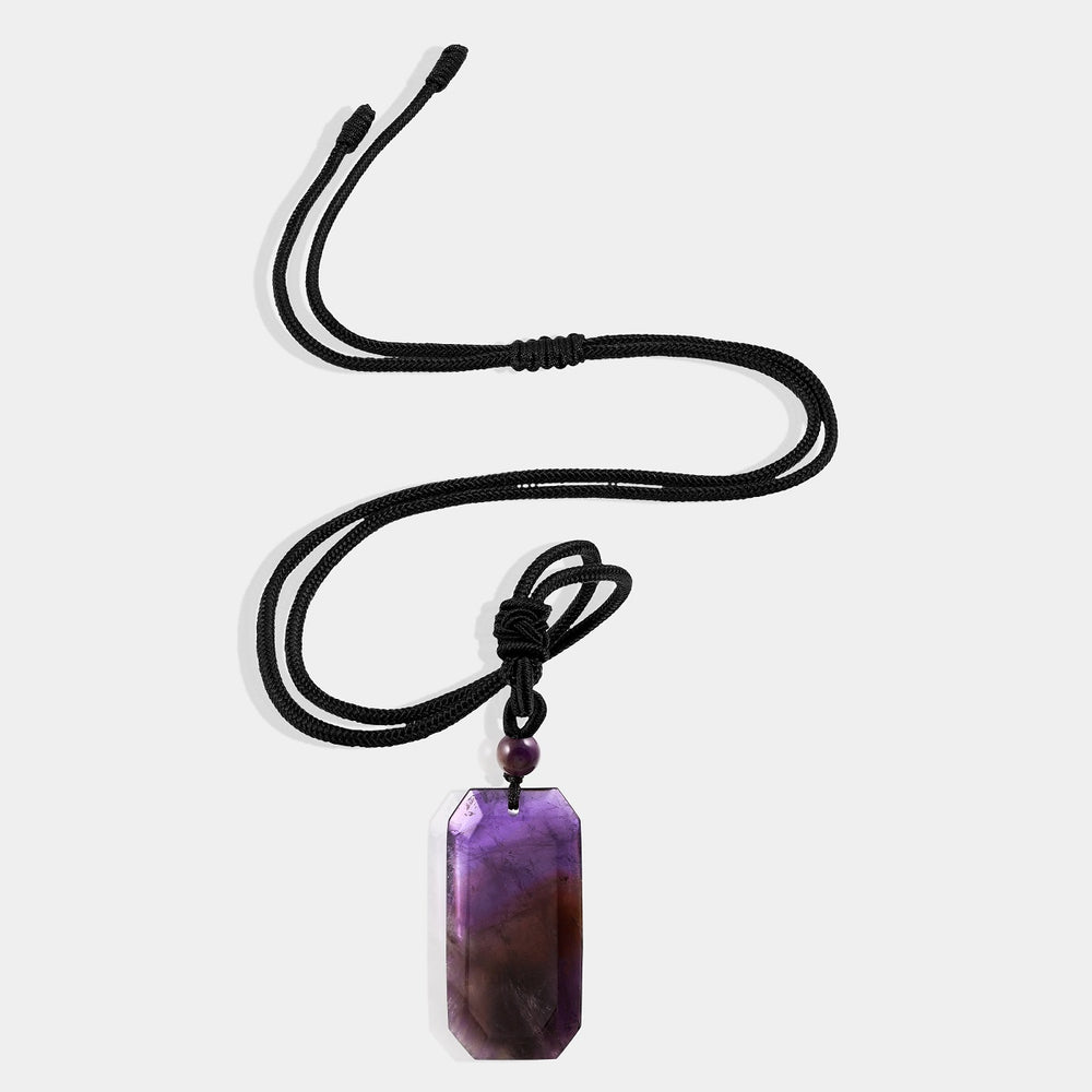 A close-up view of the pendant necklace showcasing the smooth baguette-shaped amethyst gemstone wrapped with an adjustable rope necklace, displaying its captivating purple hue.