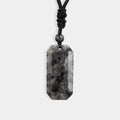 A stunning larvikite gemstone with a unique combination of black and gray hues, exhibiting its natural beauty and enchanting patterns.