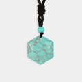 A smooth hexagon-cut turquoise gemstone, showcasing its vibrant blue-green color and unique matrix patterns.