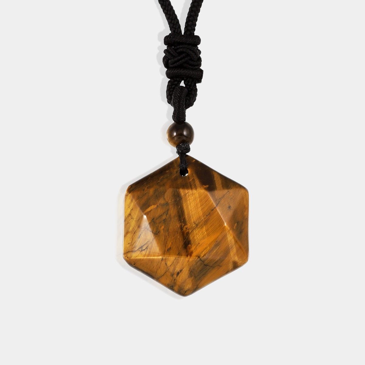 A smooth hexagon-cut Tiger's Eye gemstone, showcasing its mesmerizing golden-brown color and chatoyant effect.