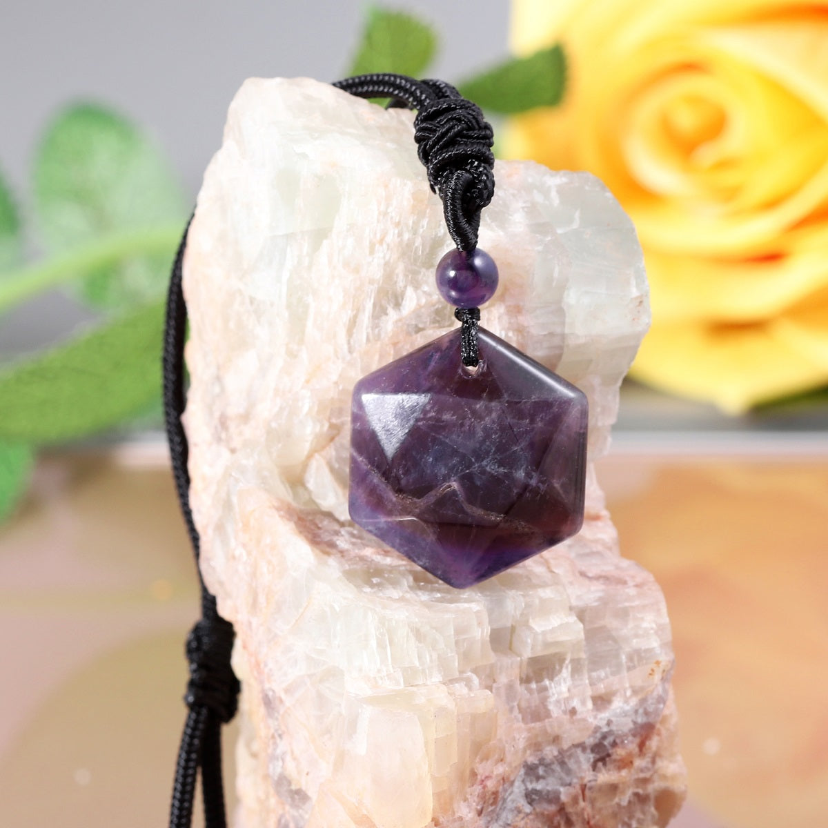 A detailed view of the artistic and intricate wrapping design that surrounds the amethyst gemstone, adding a touch of elegance to the pendant necklace.