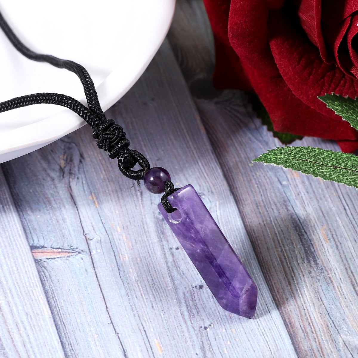 A detailed view of the artistic and intricate wrapping design that surrounds the Amethyst gemstone, adding a touch of elegance to the pendant necklace.