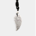 Exquisite carved wing pendant made of Howlite.