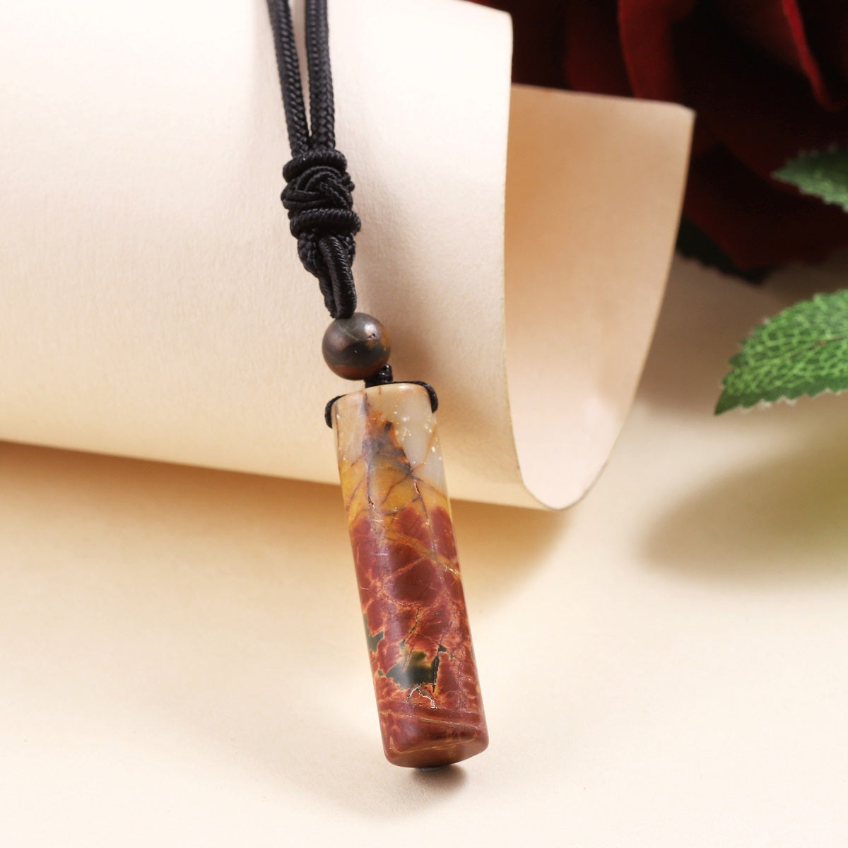 Delicate wrapped design showcasing the Red Jasper gemstone pendant.