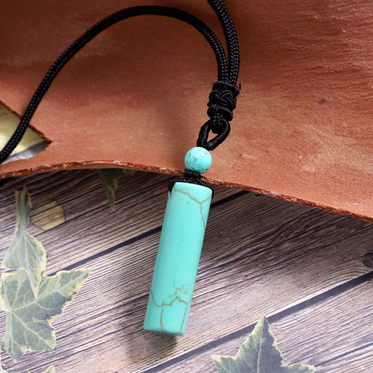 Delicate wrapped design showcasing the Turquoise gemstone pendant.