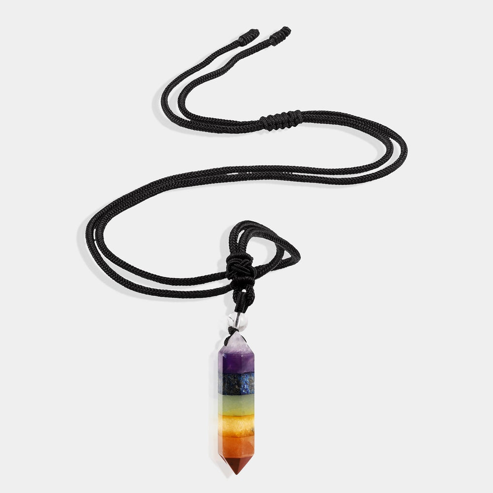 A stunning pendant necklace featuring a natural multicolor crystal quartz gemstone in a hexagon-cut, wrapped in an intricate design.