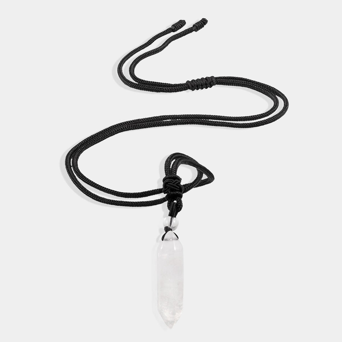 A stunning pendant necklace featuring a natural white quartz gemstone in a hexagon-cut, wrapped in an intricate design.