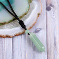 A detailed view of the artistic and intricate wrapping design that surrounds the green aventurine gemstone, adding a touch of elegance to the pendant necklace.