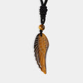 Exquisite carved wing pendant made of Tiger's Eye